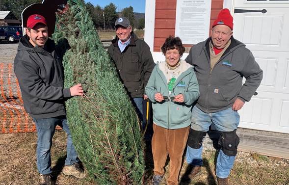 A happy family has cut down a local Christmas tree.